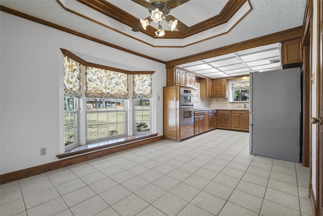 kitchen featuring ornamental molding, appliances with stainless steel finishes, and light tile patterned flooring