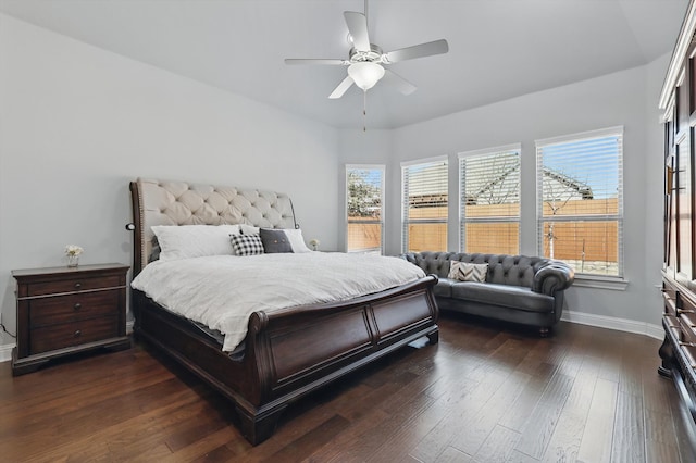 bedroom featuring baseboards, dark wood-style floors, and a ceiling fan