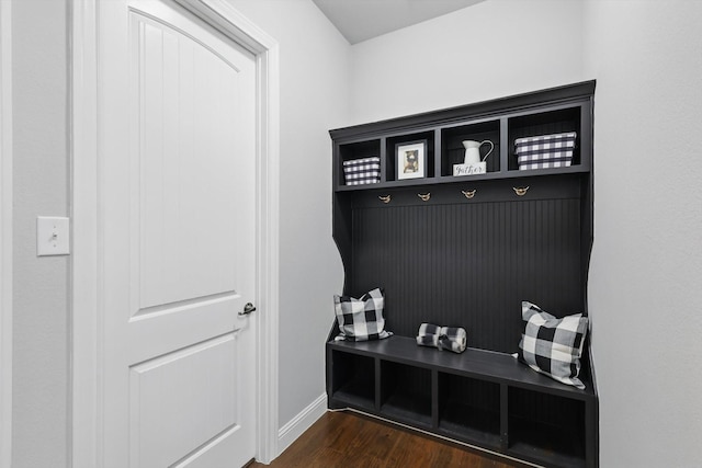 mudroom featuring baseboards and dark wood-style flooring