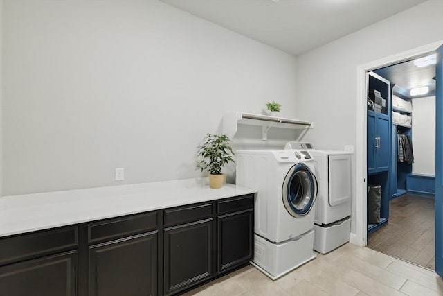 laundry area with cabinet space and washer and clothes dryer