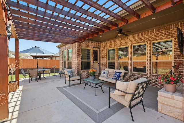 view of patio / terrace featuring ceiling fan, fence, outdoor lounge area, outdoor dining space, and a pergola