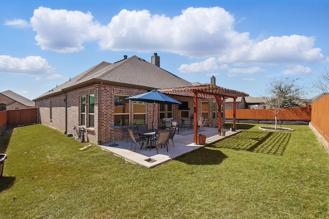 rear view of property with a fenced backyard, a pergola, a chimney, a patio area, and brick siding