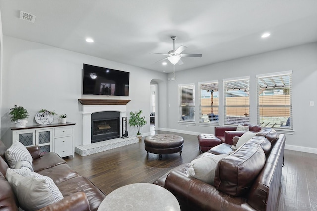 living room featuring recessed lighting, wood finished floors, arched walkways, and ceiling fan