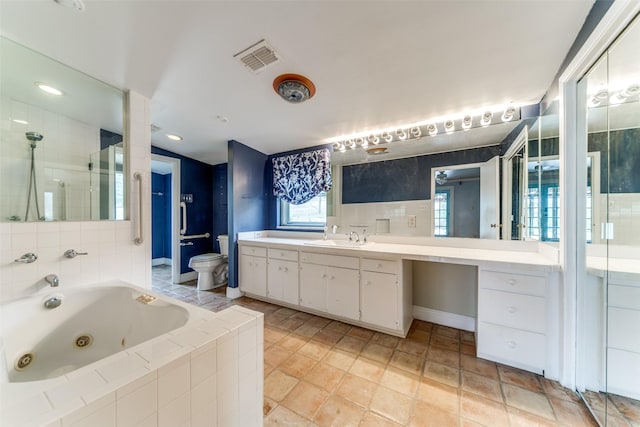 full bath featuring visible vents, toilet, vanity, tiled shower, and a tub with jets