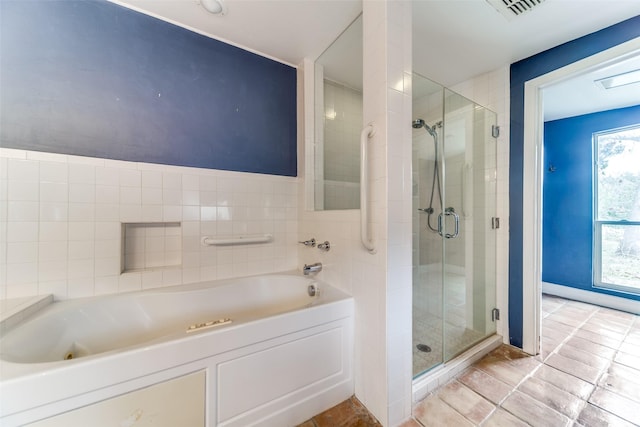 full bath featuring a stall shower, tile patterned flooring, visible vents, and a garden tub