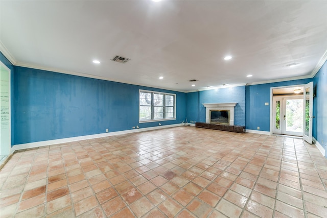 unfurnished living room featuring recessed lighting, visible vents, baseboards, a brick fireplace, and crown molding