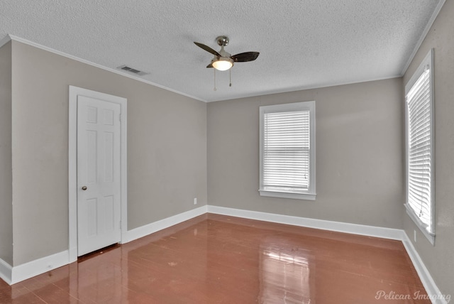 empty room with a healthy amount of sunlight, baseboards, visible vents, and a ceiling fan