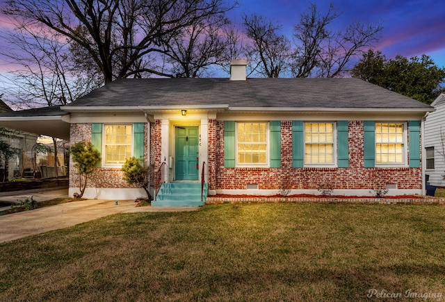 view of front of home with a chimney, crawl space, an attached carport, driveway, and a front lawn