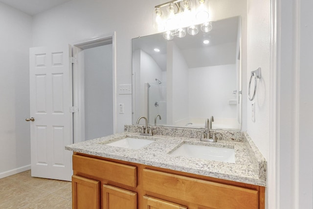 full bathroom featuring double vanity, a shower, a sink, and tile patterned floors