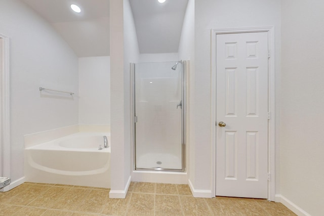 full bathroom featuring a stall shower, tile patterned flooring, a bath, and baseboards