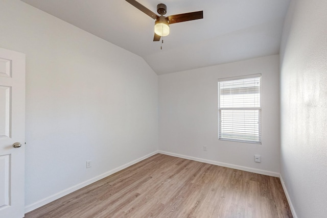 unfurnished room featuring vaulted ceiling, light wood-type flooring, a ceiling fan, and baseboards