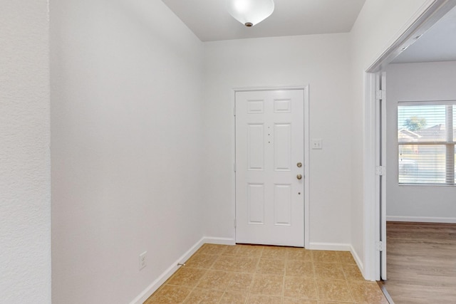 entryway featuring baseboards