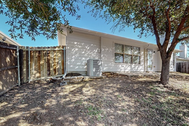 back of house featuring a patio, fence, and central air condition unit