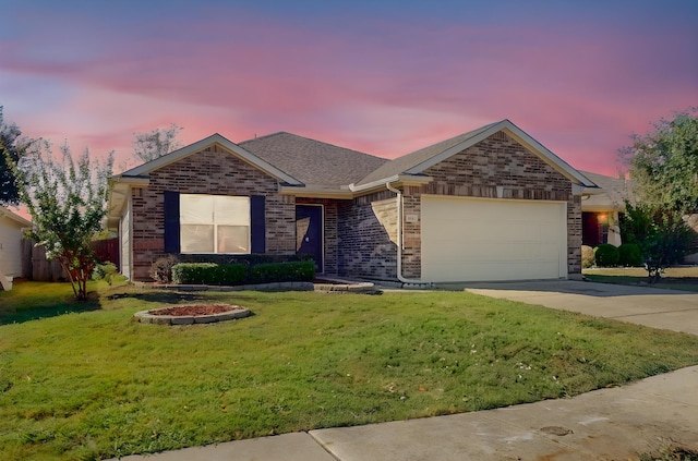 ranch-style home with a garage, concrete driveway, brick siding, and a front lawn