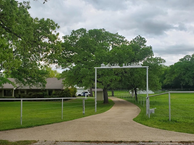 surrounding community with a yard and fence