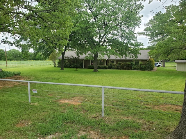 view of yard featuring a rural view and fence