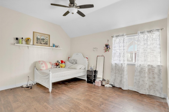 bedroom featuring lofted ceiling, wood finished floors, a ceiling fan, and baseboards