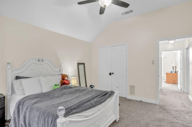 bedroom with light carpet, vaulted ceiling, a closet, and visible vents