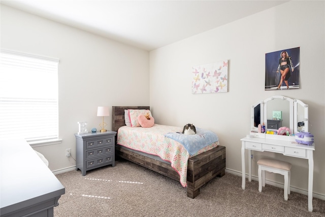 bedroom featuring carpet and baseboards