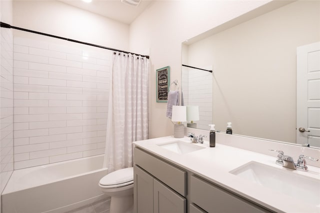 bathroom with toilet, shower / tub combo, double vanity, and a sink