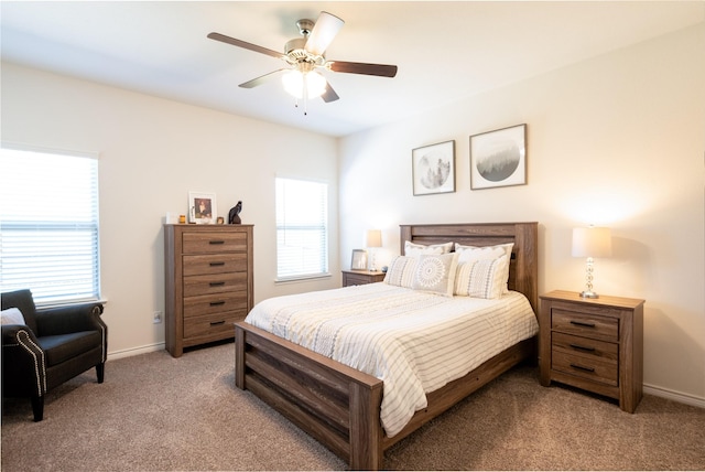 bedroom featuring baseboards, a ceiling fan, and light colored carpet