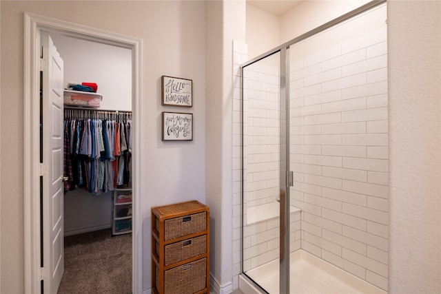 full bath with a spacious closet and a stall shower