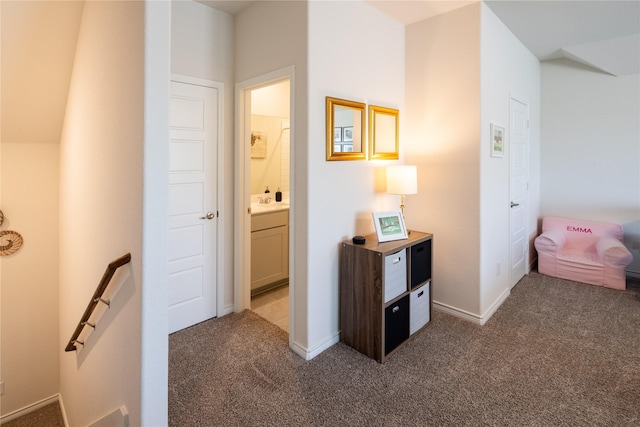 corridor with carpet and an upstairs landing