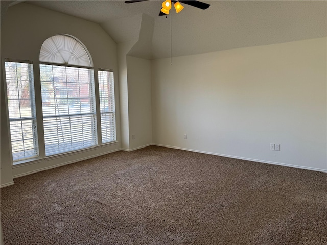 empty room with baseboards, carpet floors, ceiling fan, and vaulted ceiling