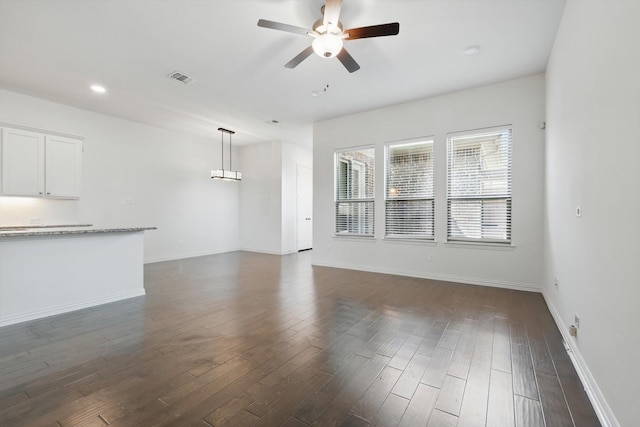 unfurnished living room featuring dark wood-style floors, recessed lighting, visible vents, ceiling fan, and baseboards