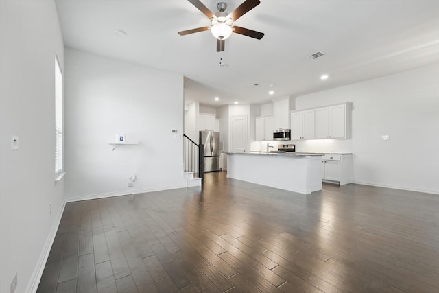 unfurnished living room featuring dark wood-style floors, visible vents, a ceiling fan, and recessed lighting