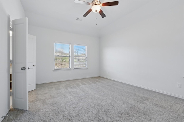 spare room featuring visible vents, carpet flooring, a ceiling fan, and baseboards