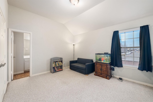 sitting room with lofted ceiling, carpet, and baseboards