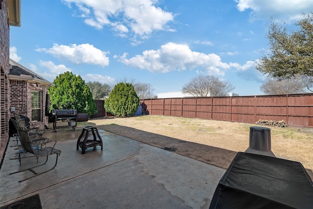 view of patio / terrace featuring a fenced backyard and a grill