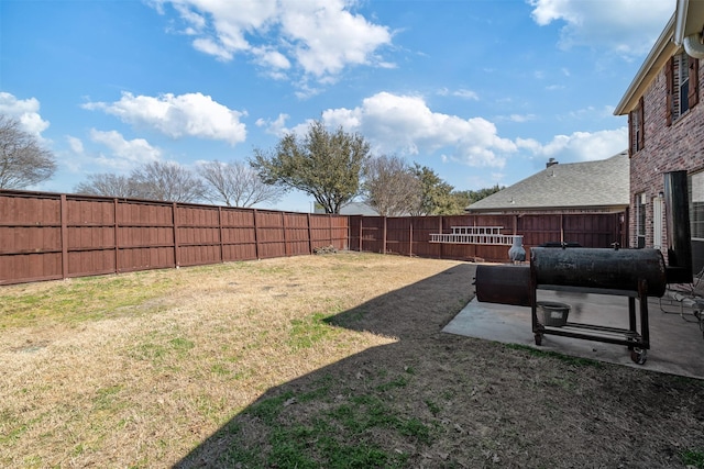 view of yard with a fenced backyard and a patio