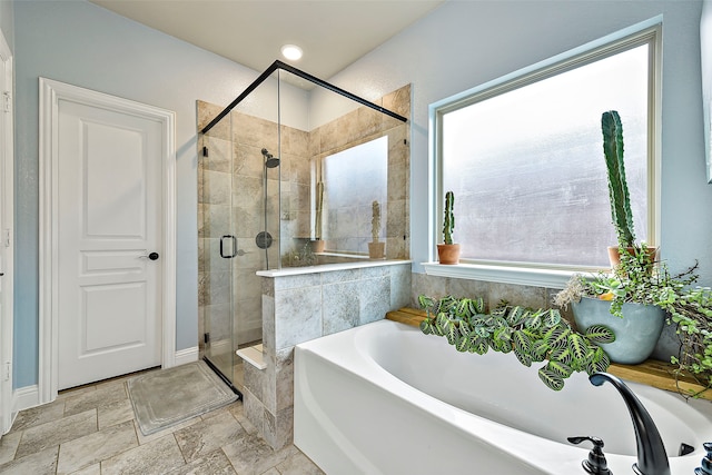 full bathroom with a stall shower and a bath