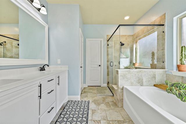 full bathroom featuring a sink, double vanity, a shower stall, and a bath