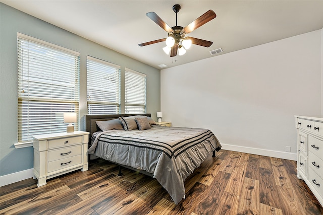 bedroom featuring baseboards, visible vents, ceiling fan, and dark wood-style flooring