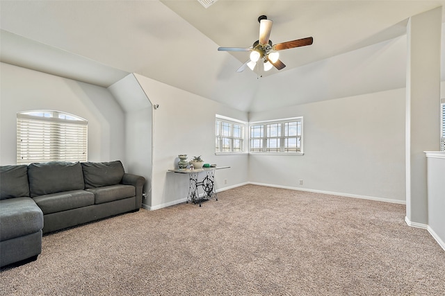 living room featuring carpet floors, vaulted ceiling, baseboards, and a ceiling fan