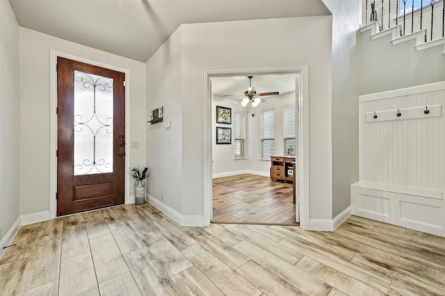 entryway featuring ceiling fan, baseboards, and wood finished floors