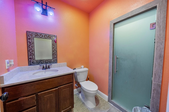 314 S Hastings St, Irving, TX 75060 - bathroom with toilet, baseboards, an enclosed shower, a textured wall, and vanity