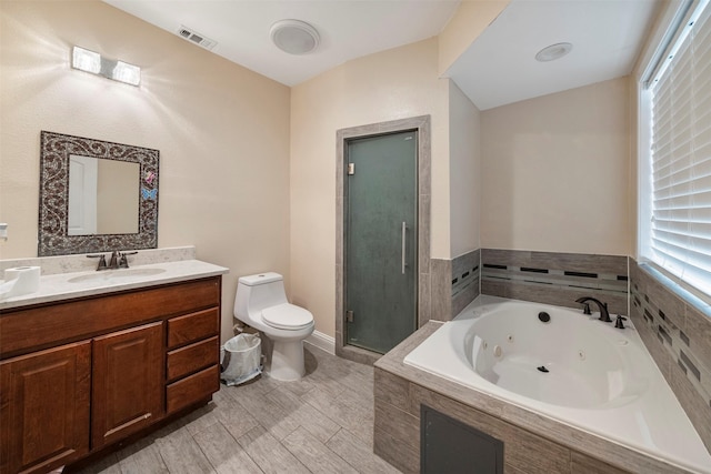 314 S Hastings St, Irving, TX 75060 - full bath with visible vents, toilet, a tub with jets, vanity, and a stall shower