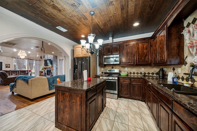 kitchen with visible vents, backsplash, appliances with stainless steel finishes, a sink, and wooden ceiling