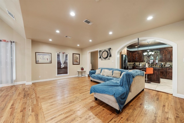 314 S Hastings St, Irving, TX 75060 - living area featuring arched walkways, light wood-style floors, visible vents, and recessed lighting