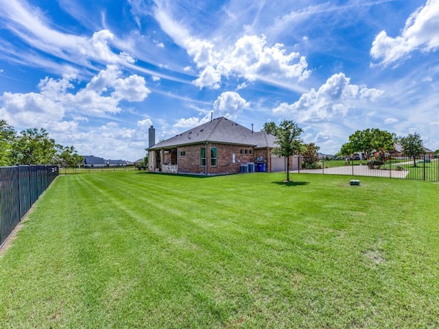 view of yard with fence and central air condition unit