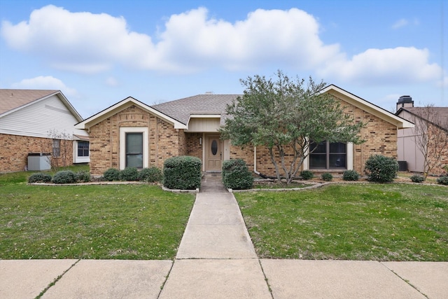 view of front of house featuring a shingled roof, brick siding, central AC, and a front lawn