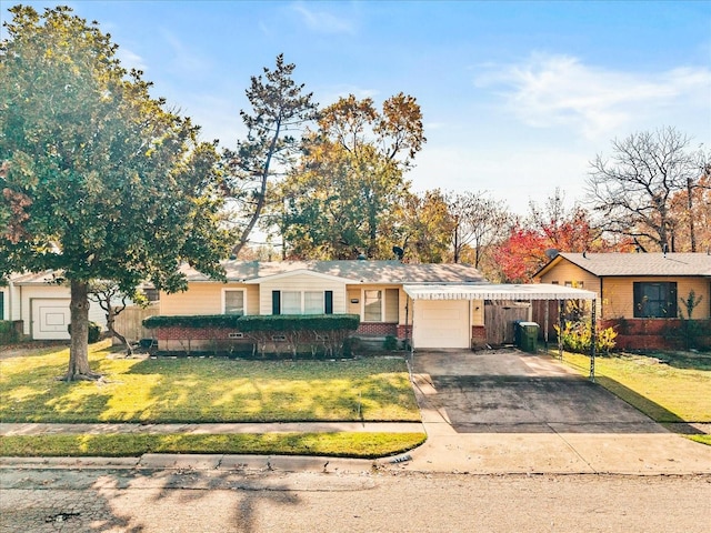 ranch-style house featuring a garage, concrete driveway, a carport, and a front yard