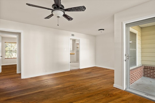 unfurnished room featuring a ceiling fan, visible vents, baseboards, and wood finished floors