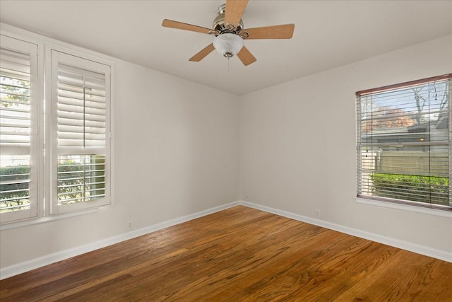 unfurnished room featuring ceiling fan, baseboards, and wood finished floors