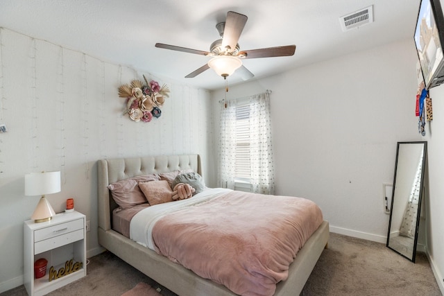 bedroom featuring light carpet, baseboards, visible vents, and ceiling fan