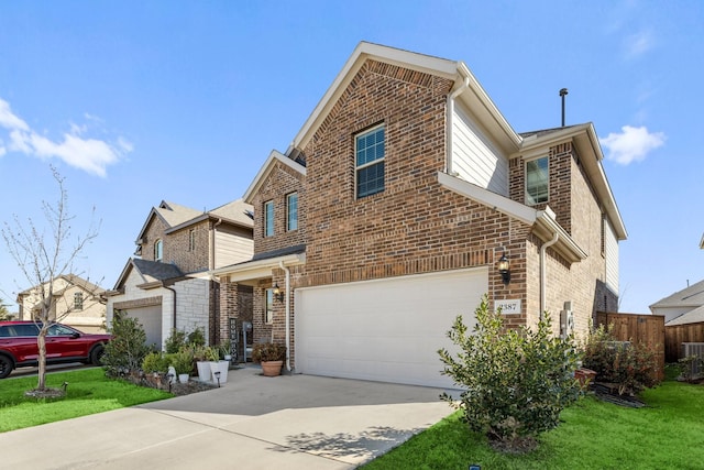 view of front facade with a front yard, concrete driveway, brick siding, and an attached garage